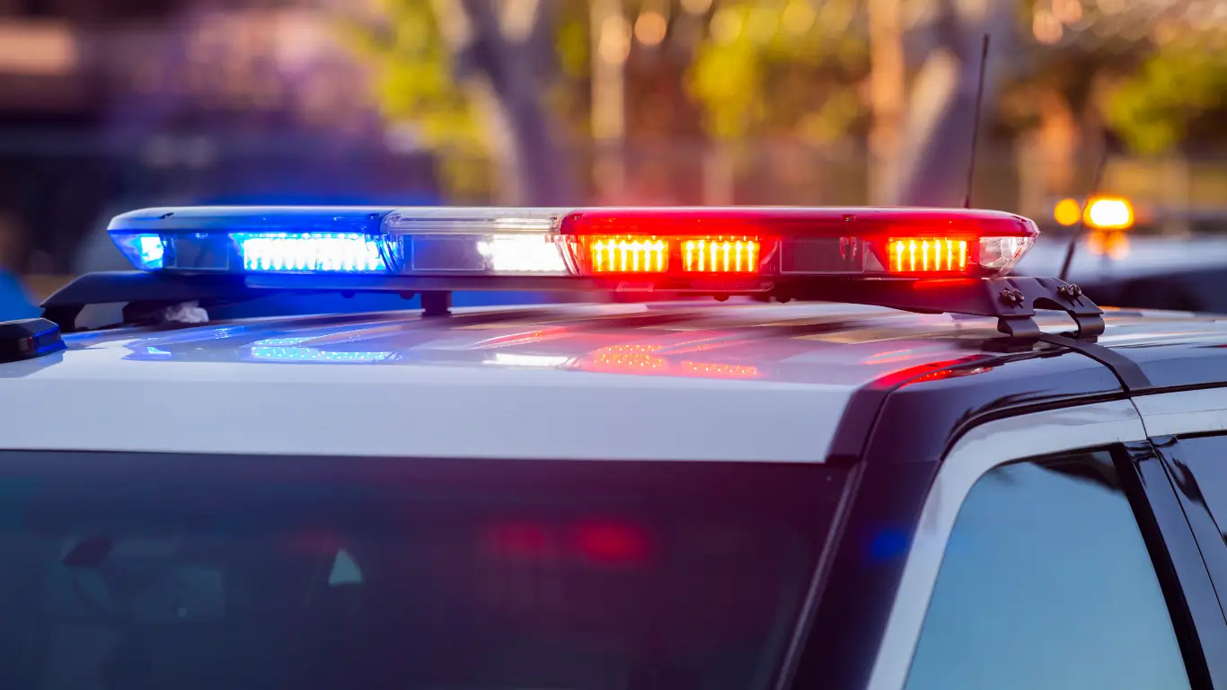  Flashing red and blue police lights on top of a patrol vehicle.